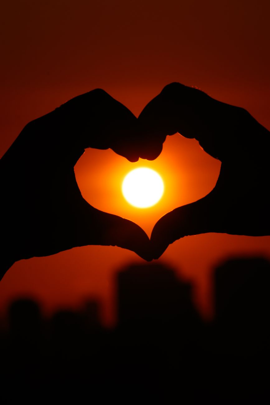silhouette heart and sunset over brazilian city
